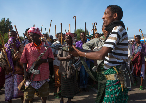 Oromo men with kalashnikovs during a wedding celebration, Oromo, Sambate, Ethiopia