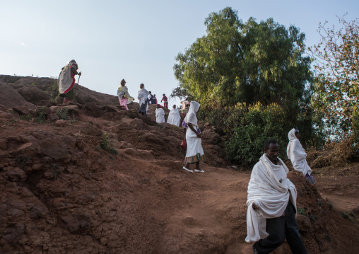 Ethiopian people walking along a hill, Amhara region, Lalibela, Ethiopia