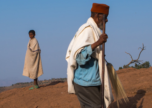 Ethiopian priests walking along a hill, Amhara region, Lalibela, Ethiopia