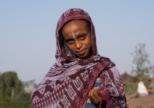 Pilgrim woman with a cross sign on the forehead during kidane mehret celebration, Amhara region, Lalibela, Ethiopia