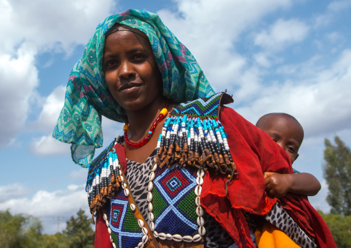Raya tribe woman with a beaded baby carrier, Semien wollo zone, Woldia, Ethiopia