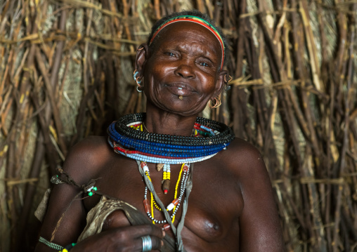 Toposa tribe woman in her hut, Omo valley, Kangate, Ethiopia