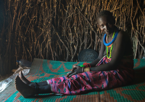 Toposa tribe woman sit in her hut, Omo valley, Kangate, Ethiopia
