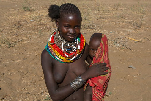 Murle tribe woman with her baby, Omo valley, Kangate, Ethiopia