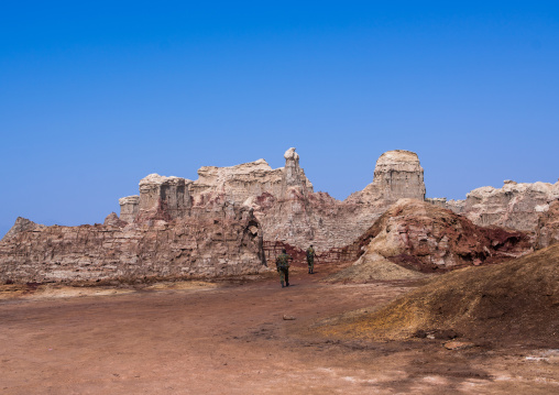 Ethiopian soldiers in the salt canyons made of layers of halite and gypsum in the danakil depression, Afar region, Dallol, Ethiopia