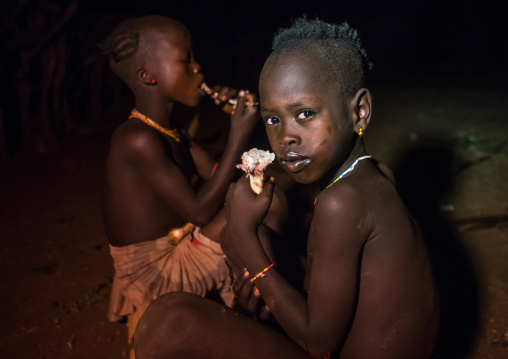 Hamer tribe boys eating goat meat, Omo valley, Turmi, Ethiopia