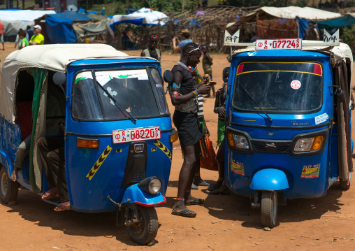 Tsemay tribe man negociating the price of a tuk tuk taxi, Omo valley, Key afer, Ethiopia