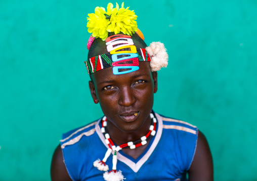 Portrait of a bana tribe man with yellow plastic flower in the hair, Omo valley, Key afer, Ethiopia