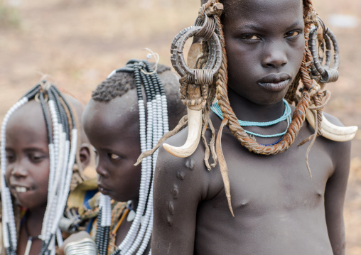 Mursi tribe children with adornments on the heads, Omo valley, Mago park, Ethiopia