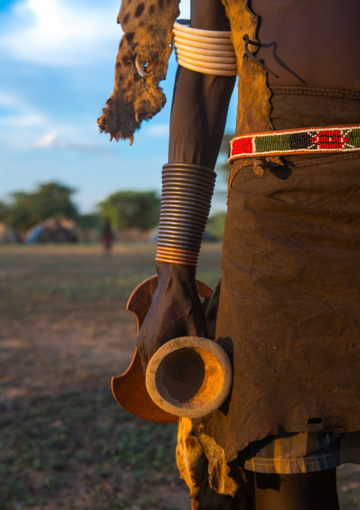 Dassanech man with his wooden pillow during dimi ceremony to celebrate circumcision of the teenagers, Omo valley, Omorate, Ethiopia