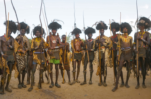 Dassanech men with leopard skins and ostrich feathers headwears during dimi ceremony to celebrate circumcision of teenagers, Omo valley, Omorate, Ethiopia