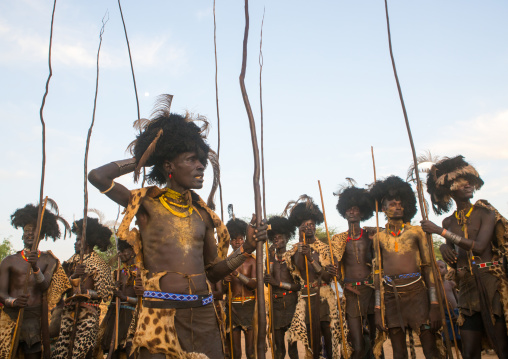 Dassanech men with leopard skins and ostrich feathers headwears during dimi ceremony to celebrate circumcision of teenagers, Omo valley, Omorate, Ethiopia