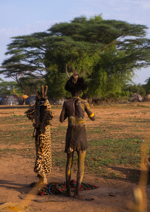Dassanech man dressing with a ostrich feathers headwear for dimi ceremony to celebrate circumcision of the teenagers, Omo valley, Omorate, Ethiopia