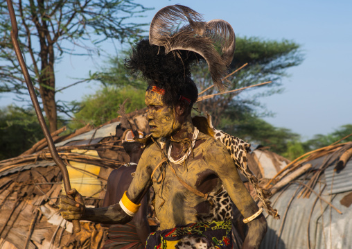 Dassanech man with leopard skin and ostrich feathers headwear during dimi ceremony to celebrate circumcision of teenagers, Omo valley, Omorate, Ethiopia