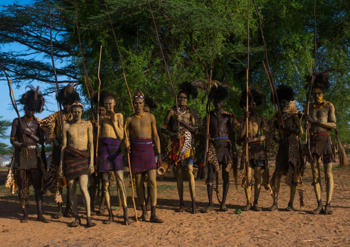 Dassanech men with leopard skins and ostrich feathers headwears during dimi ceremony to celebrate circumcision of teenagers, Omo valley, Omorate, Ethiopia