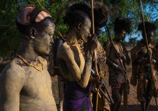 Dassanech men with leopard skins and ostrich feathers headwears during dimi ceremony to celebrate circumcision of teenagers, Omo valley, Omorate, Ethiopia