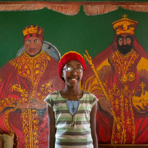 Rastafari girl called kizzy in front of haile selassie and his wife mural, Oromo, Shashamane, Ethiopia