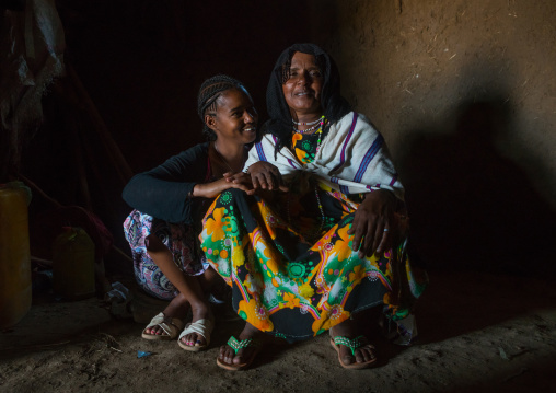 A karrayyu tribe girl called aliya who was the first girl educated in her tribe pausing with her mother, Oromia, Metehara, Ethiopia