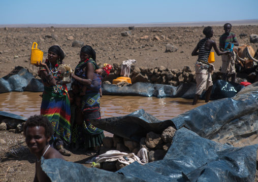 Somali people collecting water in a tank in the desert, Afar region, Yangudi rassa national park, Ethiopia