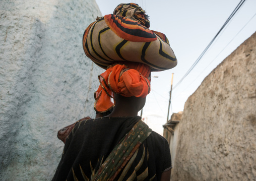 Ethiopian girl in the street carrying a bag on her head, Harari region, Harar, Ethiopia