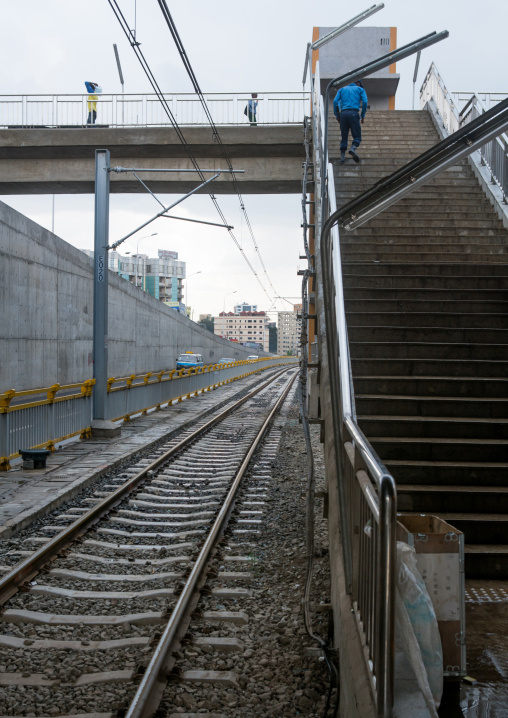 Man walking up stairs from ethiopian railways constructed by china, Addis abeba region, Addis ababa, Ethiopia