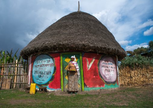 Ethiopia, Kembata, Alaba Kuito, ethiopian woman standing in front of her traditional painted house