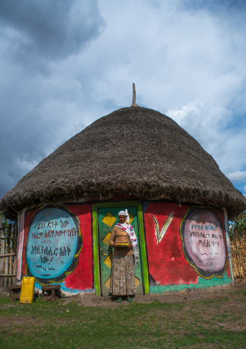 Ethiopia, Kembata, Alaba Kuito, ethiopian woman standing in front of her traditional painted house
