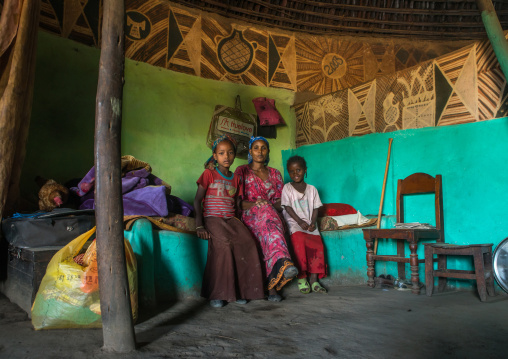 Ethiopia, Kembata, Alaba Kuito, ethiopian woman with her children inside her traditional painted and decorated house