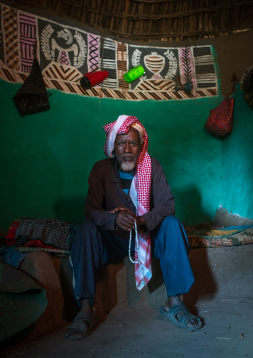 Ethiopia, Kembata, Alaba Kuito, ethiopian muslim man inside his traditional painted and decorated house