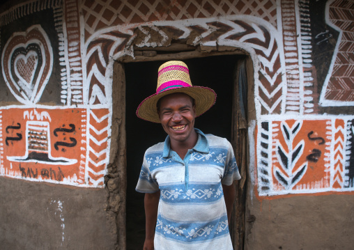 Ethiopia, Kembata, Alaba Kuito, ethiopian man with a hat standing in front of his traditional painted house