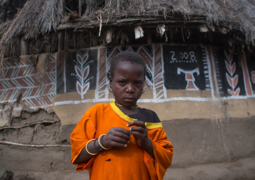 Ethiopia, Kembata, Alaba Kuito, ethiopian boy standing in front of his traditional painted house