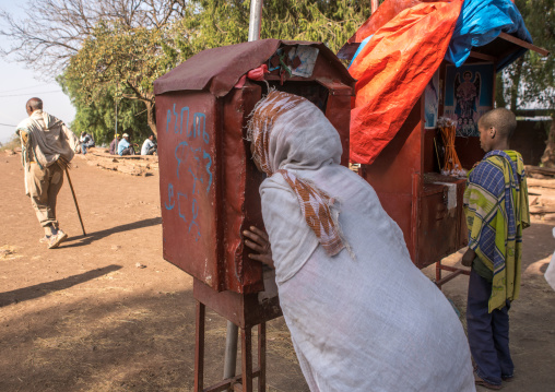 Pilgrim woman praying during kidane mehret orthodox celebration, Amhara region, Lalibela, Ethiopia
