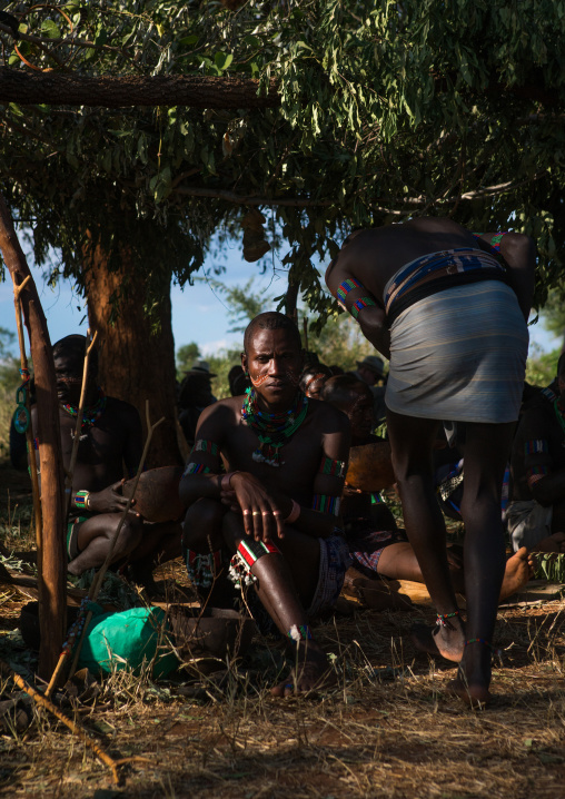 Hamer tribe whippers resting during a bull jumping ceremony, Omo valley, Turmi, Ethiopia