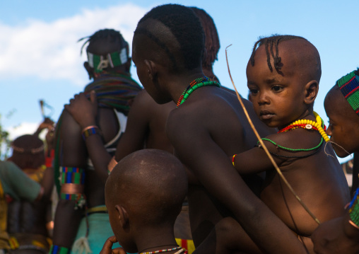 Hamer tribe children attending a bull jumping ceremony, Omo valley, Turmi, Ethiopia