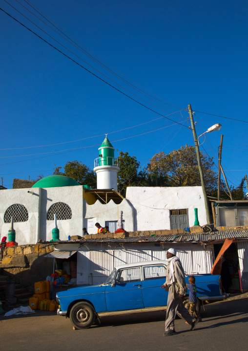 Old Peugeot 404 taxi in front of a mosque, Harari Region, Harar, Ethiopia