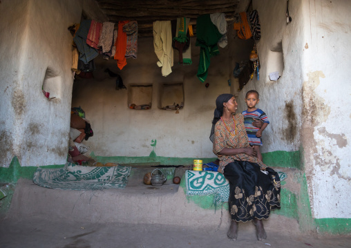 Mother and child inside their traditional Argoba stone house, Harari Region, Koremi, Ethiopia