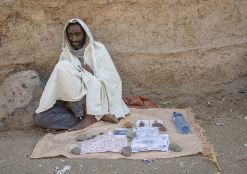 Poor man suffering with AIDS begging for money in the street, Afar region, Assaita, Ethiopia