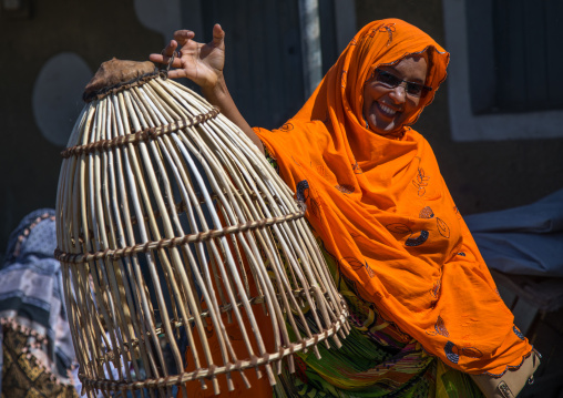 Afar women with a basket used to dry the clothes, Afar region, Assaita, Ethiopia