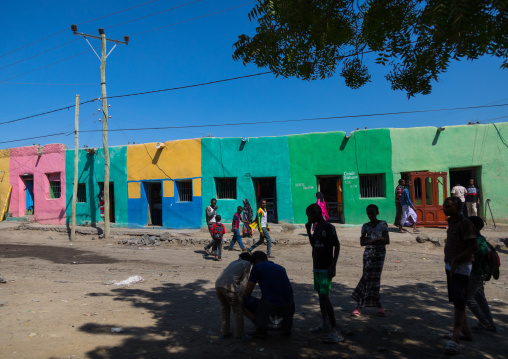 Afar people in front multi colored houses, Afar region, Assaita, Ethiopia