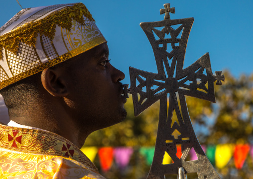 Ethiopian orthodox priest with a cross celebrating the colorful Timkat epiphany festival, Amhara region, Lalibela, Ethiopia
