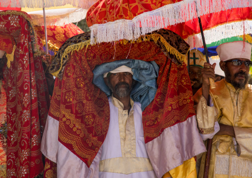 Ethiopian priest carrying a covered tabot on his head during Timkat epiphany festival, Amhara region, Lalibela, Ethiopia