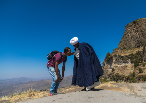 Priest of the ethiopian orthodox church blessing a pilgrim, Amhara region, Lalibela, Ethiopia