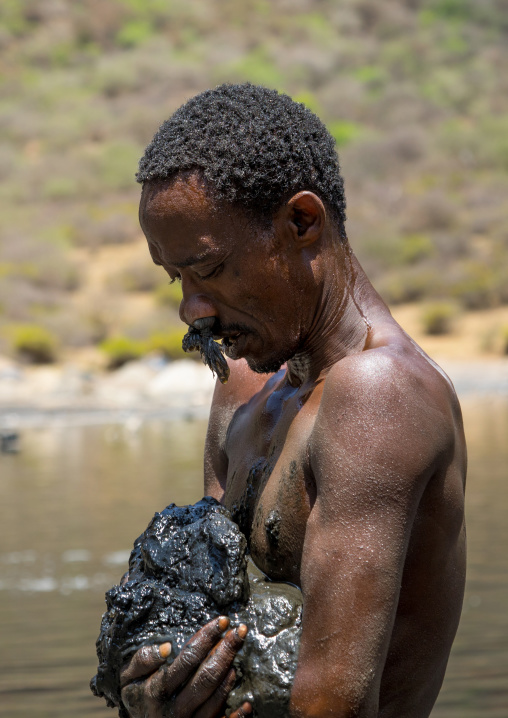 Borana tribe man ready to dive in the volcano crater to collect salt, Oromia, El Sod, Ethiopia