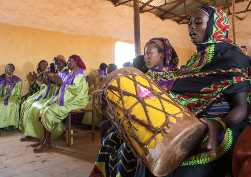 Borana woman playing drum during sunday church service, Oromia, Yabelo, Ethiopia