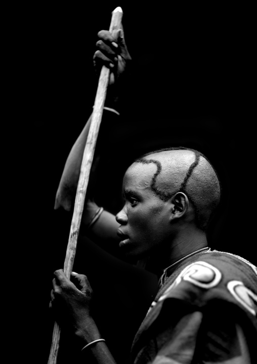 Menit young man holding a stick, Tum market, Omo valley, Ethiopia
