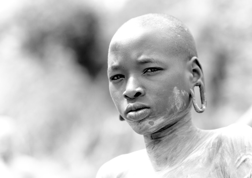 Clay body paintings on Suri warriors before donga stick fighting, Turgit village, Omo valley, Ethiopia