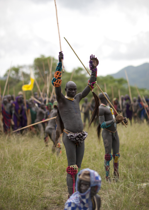 Suri tribe warriors fighting during a donga stick ritual, Omo valley, Tulgit, Ethiopia