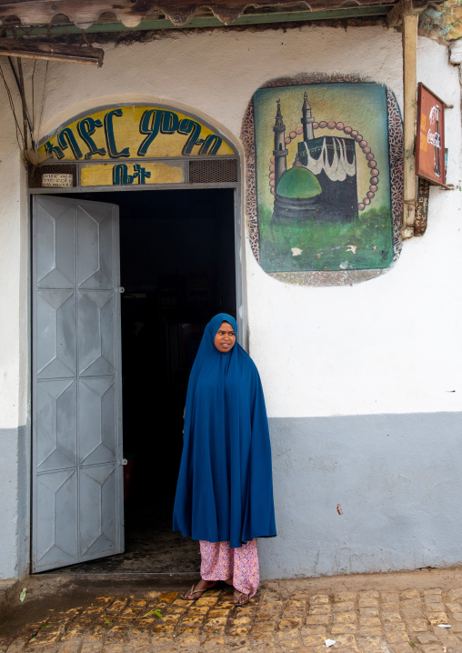 Ethiopian woman in hijab in front of a muslim restaurant, Harari region, Harar, Ethiopia
