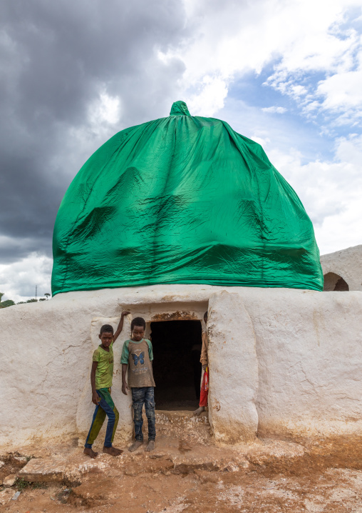 Oromo pilgrims children in front of a shrine with green dome, Oromia, Sheik Hussein, Ethiopia