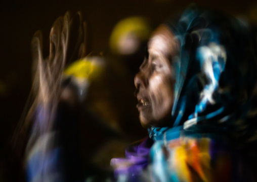 Oromo pilgrim woman praying in the night during the pilgrimage, Oromia, Sheik Hussein, Ethiopia